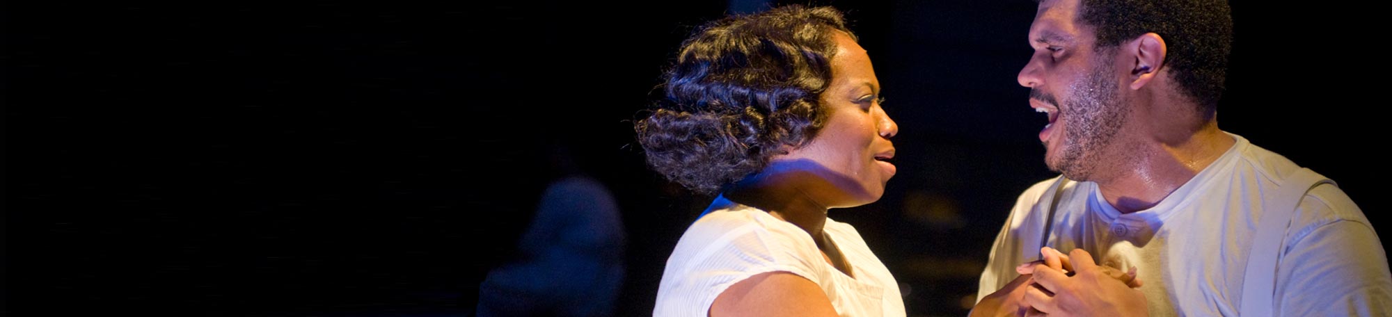 Alexis J. Rogers as Bess and Todd M. Kryger as Porgy embrace in a scene from Court Theatre's Porgy and Bess show. Work on the production included research and input of University of Chicago scholars.