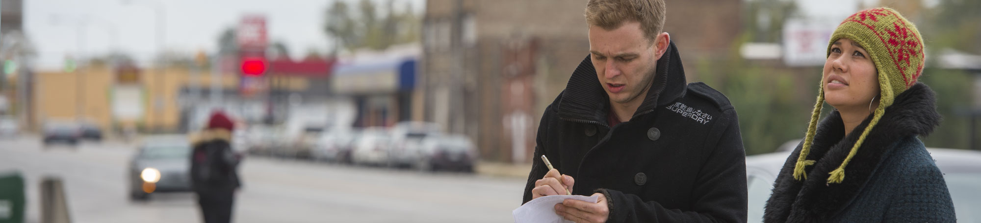 Harris School alum Jocelyn Hare works with Eric Baxter collect data for a land parcel survey in Gary, Ind.