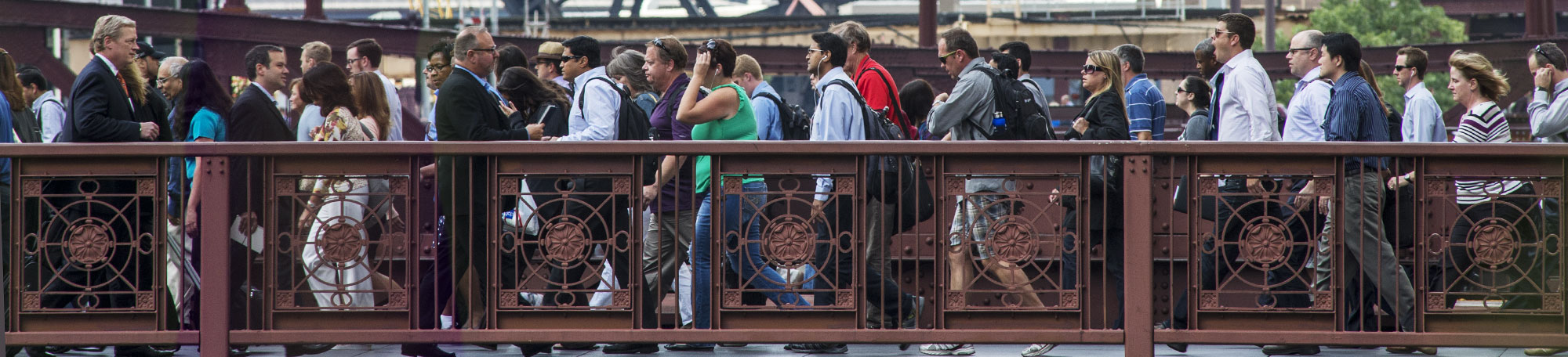 Downtown Chicago commuters make their way across the Madison Street bridge.