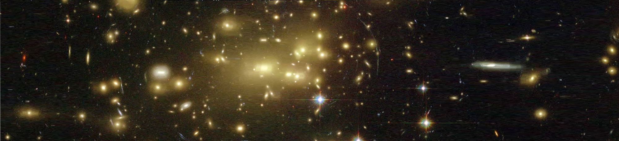 The gravity of galaxy cluster Abell 2218 bends and focuses the light from galaxies that lay behind it in this Hubble Space Telescope image. The effect distorts multiple images of the background galaxies into long, faint arcs. Credit and Copyright: NASA, A