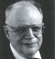 Clemens C.J. Roothaan, wearing glasses, smiles.