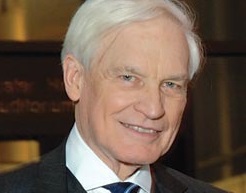 Donald W. King, wearing a suit, smiles in a close-up.