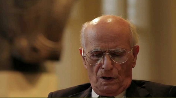 Heshmat Moayyad stands near an exhibit sculpture.