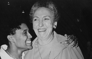 Mary Jean Mulvaney smiles while side-hugging a person.