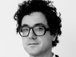 Michael Rossi, wearing glasses.