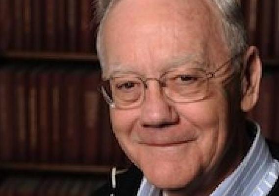 Michael Murrin, with glasses, smiling.