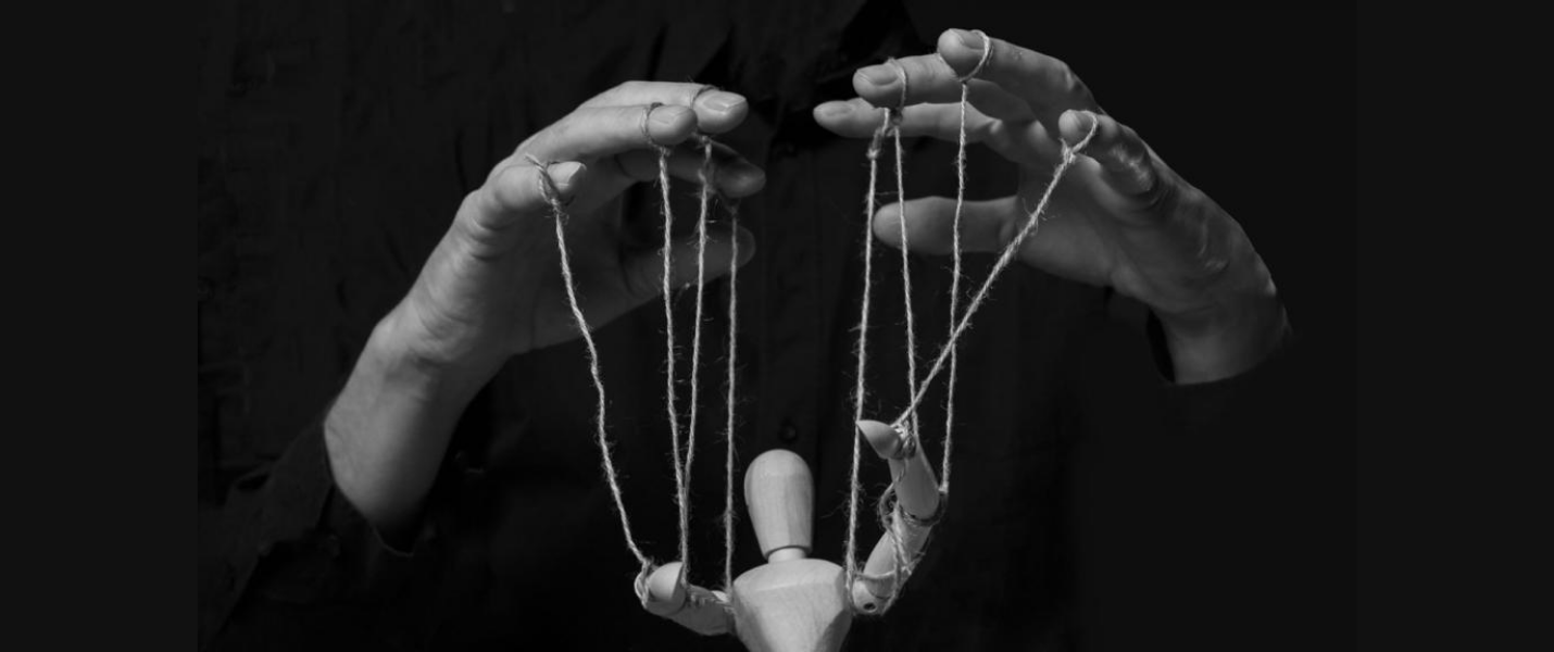 Hands manipulating a puppet