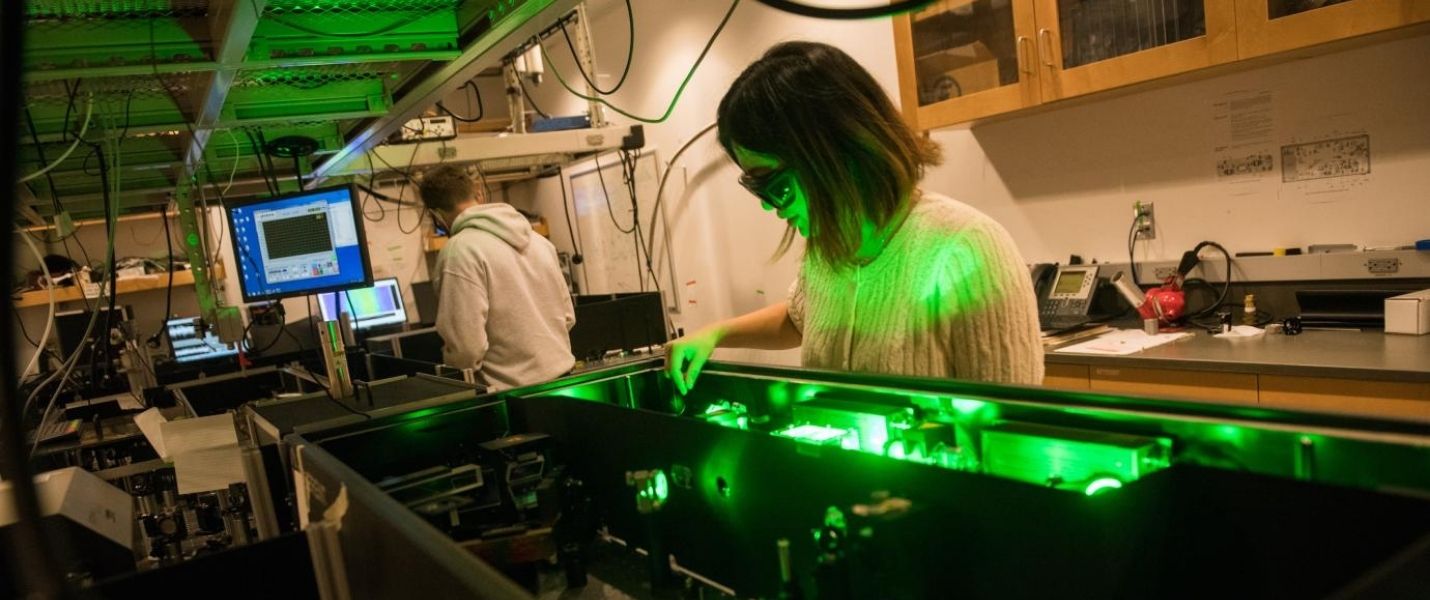 students at the laser in Greg Engel's lab