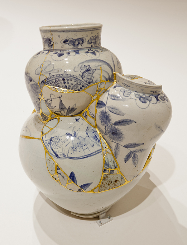 A bulbous ceramic sculpture made from vase fragments with gold joints 