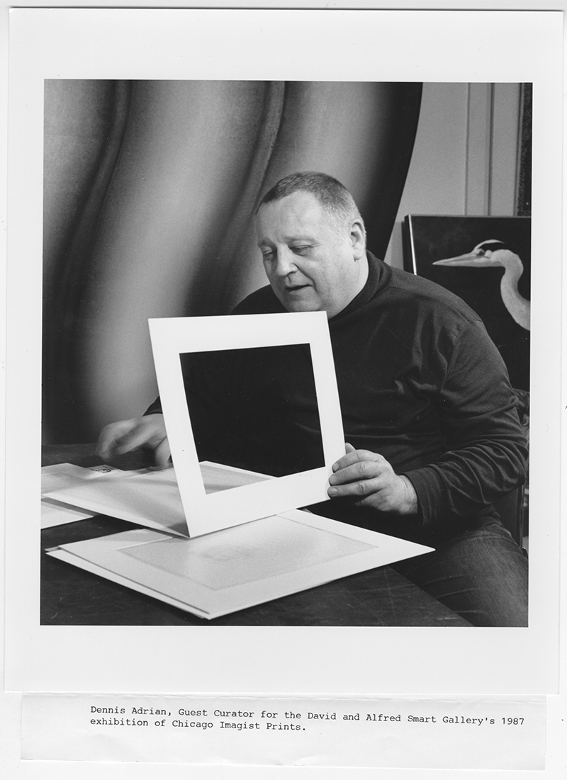 Photo of Dennis Adrian, curator of The Chicago Imagist Print, looking at prints at a desk, 1987