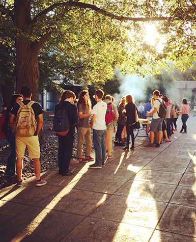 Students line up for hot dogs in the sculpture garden