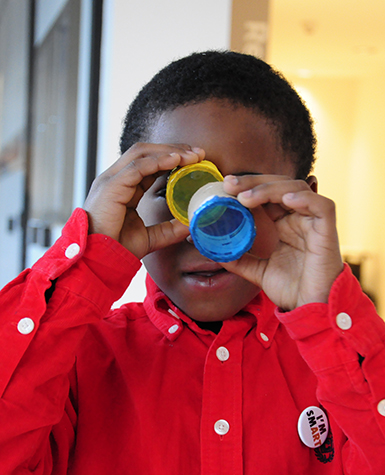 Boy with color telescope. Photo by Erik L. Peterson.