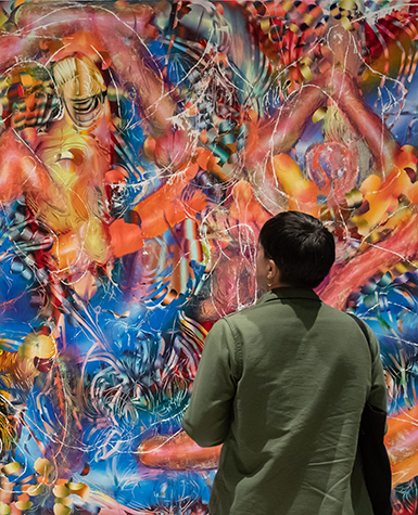 A person looks at a large abstract painting