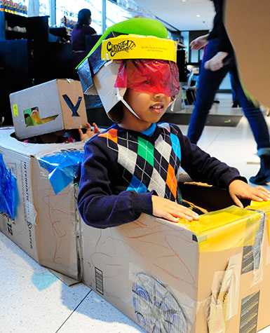 Kids making cardboard art. Photo by Erik L. Peterson.