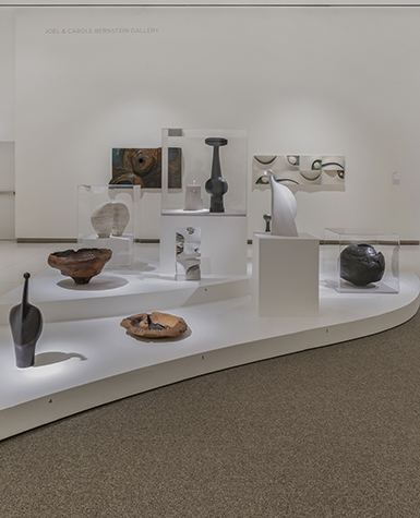 View of ceramic sculptures displayed on a curving platform