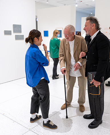 People talking and laughing in a museum gallery