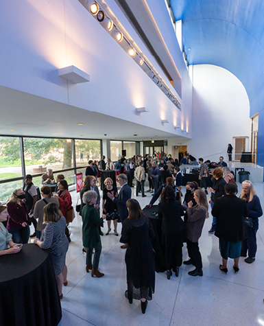 A crowd of people socializing during a reception