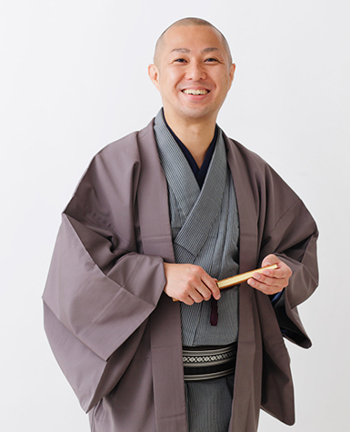 Portait of Sanyūtei Ponta in traditional Japanese dress holding a fan