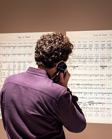 A person holds a telephone handset to their ear
