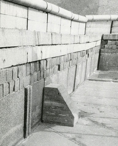 Wolf Vostell, Untitled [Betonstuhl during the Happening Desastres at the Berlin Wall], 1972. Photo by Jürgen Müller-Schneck. Art © The Wolf Vostell Estate.
