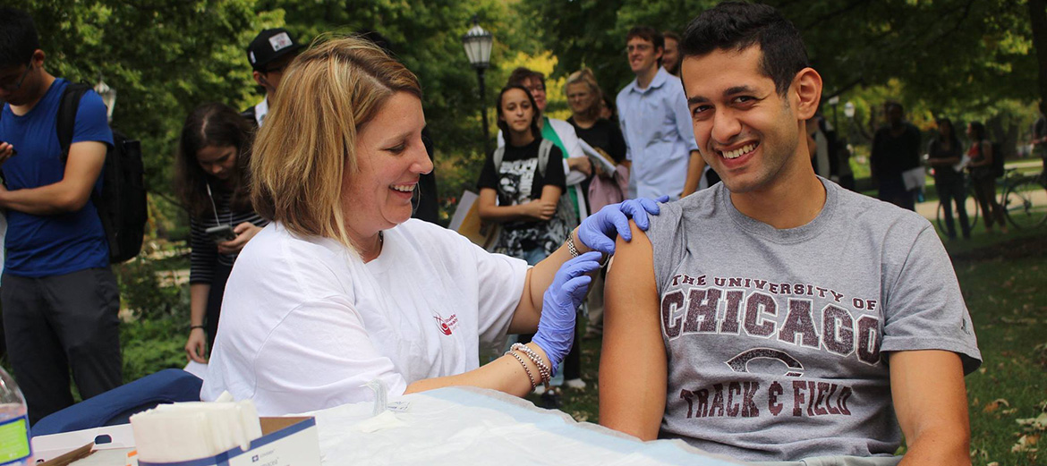 Student receiving flu shot at Wellapalooza.